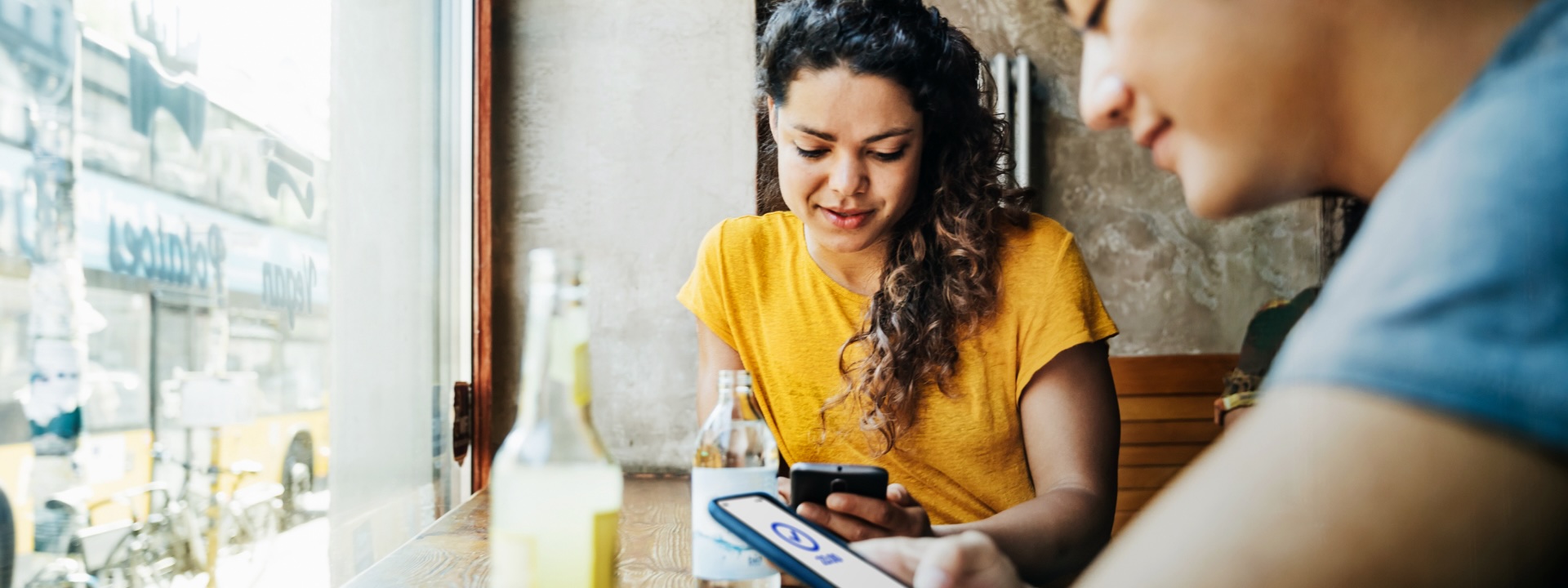 Person paying friend using mobile devide