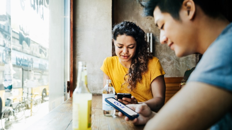 Person paying friend using mobile device